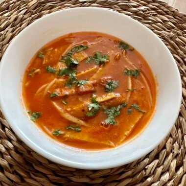 Chinese tomato soup decorated with coriander