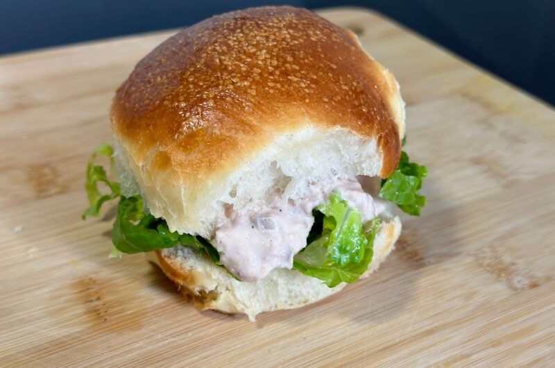 Delicious tuna salad sandwich with salad on a wooden board