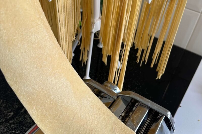 Passing pasta dough through the pasta machine