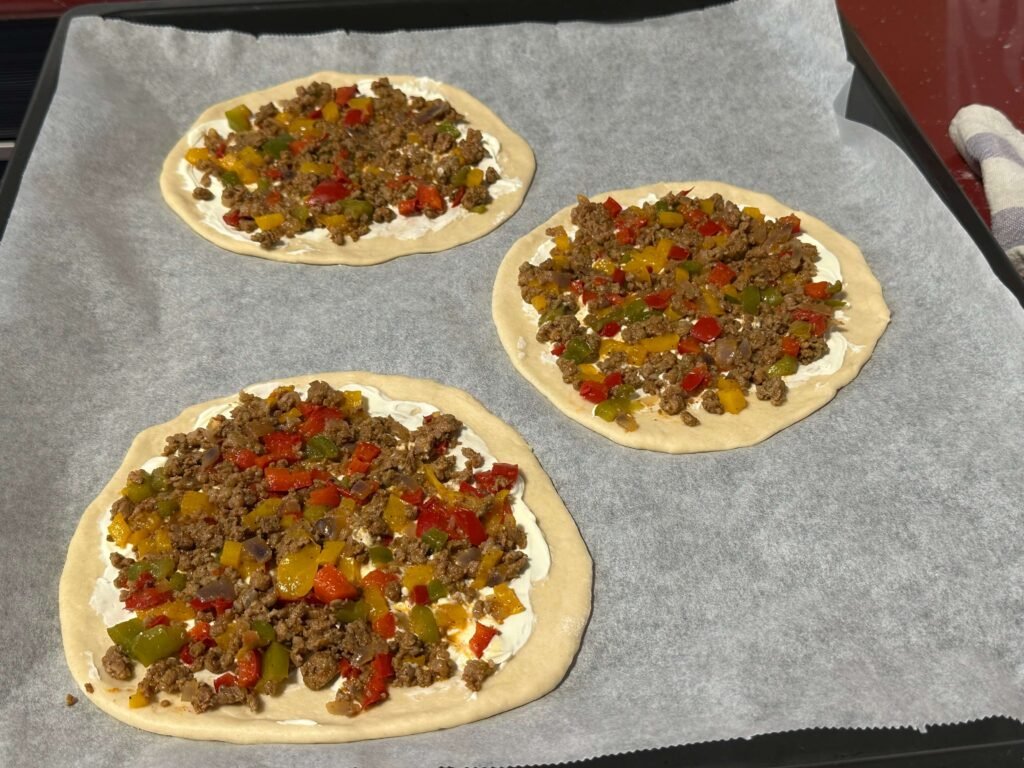 pizza base with cream cheese and minced meat