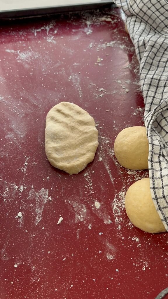 flattened dough in oval shape