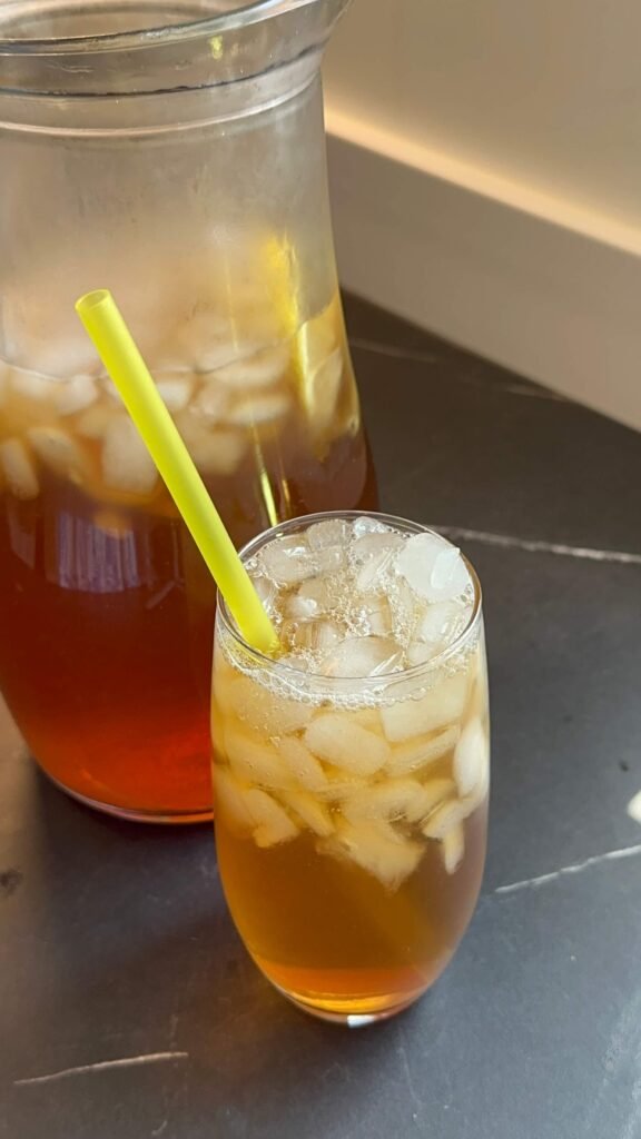 glass of homemade Nestea with ice and a yellow straw