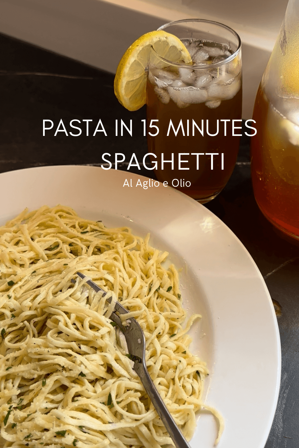 Pasta dish with garlic spaghetti, extra virgin olive oil, parsley, and Parmesan cheese accompanied by a glass of homemade Nestea
