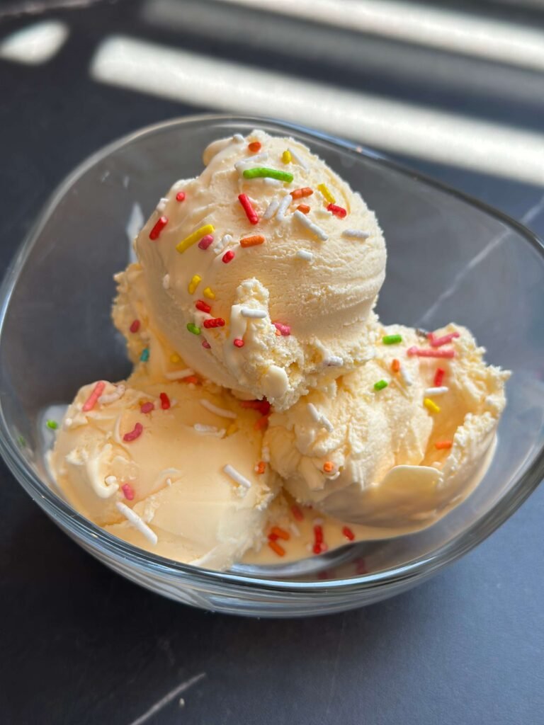 Homemade vanilla ice cream balls with colorful noodles